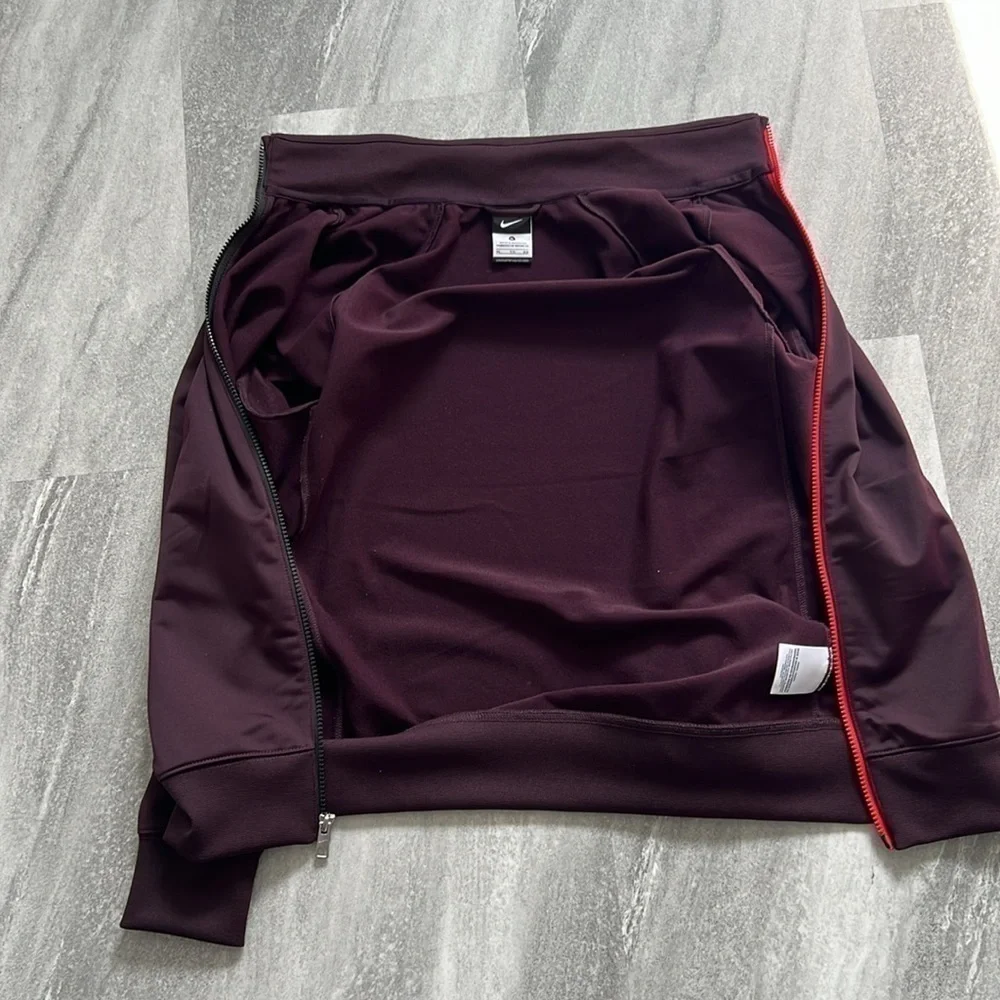 Maroon Nike Jacket size XL Youth black and orange detailing fits womens M/L